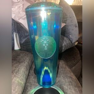 New, never been used. Turquoise starbucks tumbler.